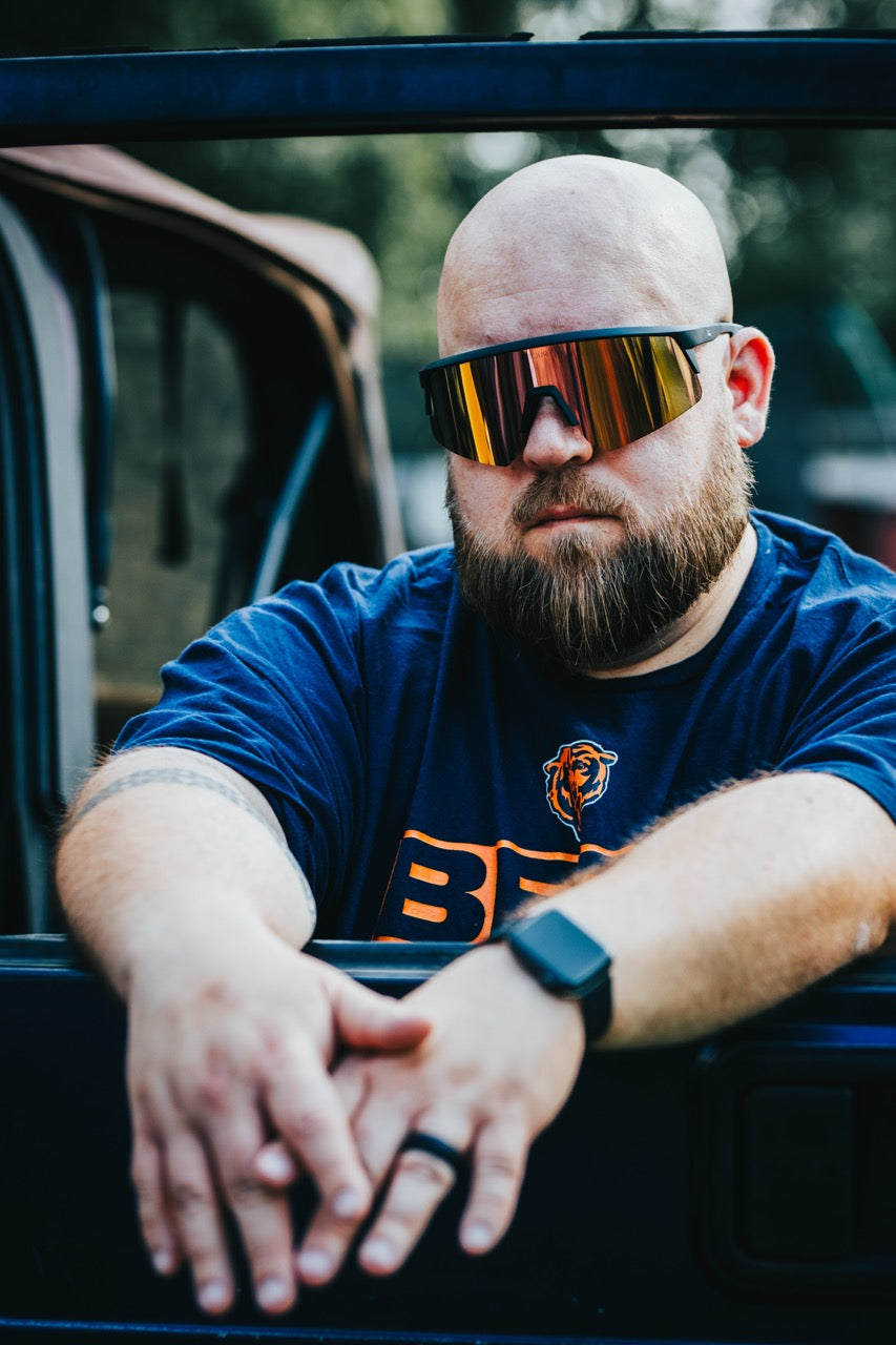 Snowboarder carving through powder in snowy terrain.