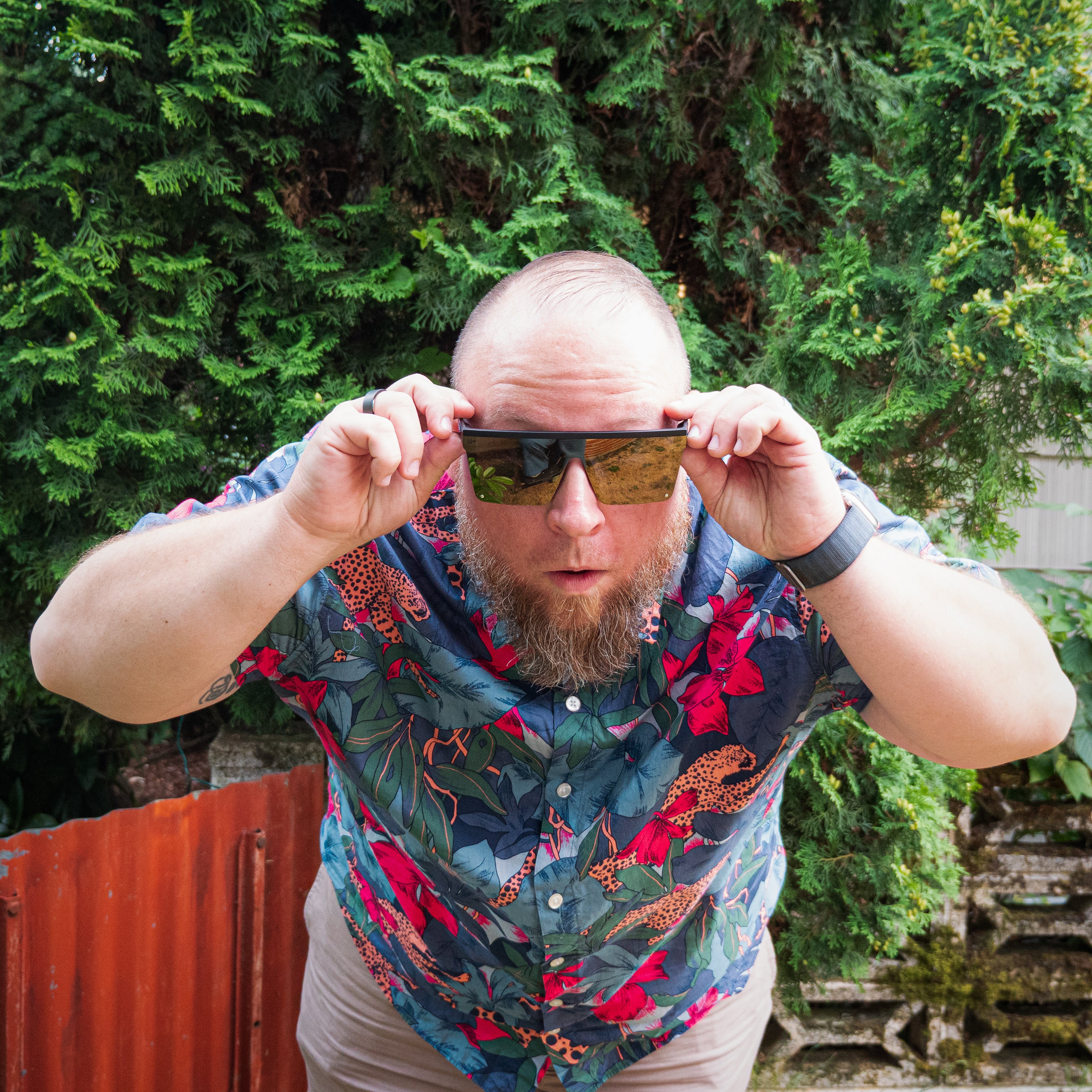 Snowboarder carving through powder in snowy terrain.