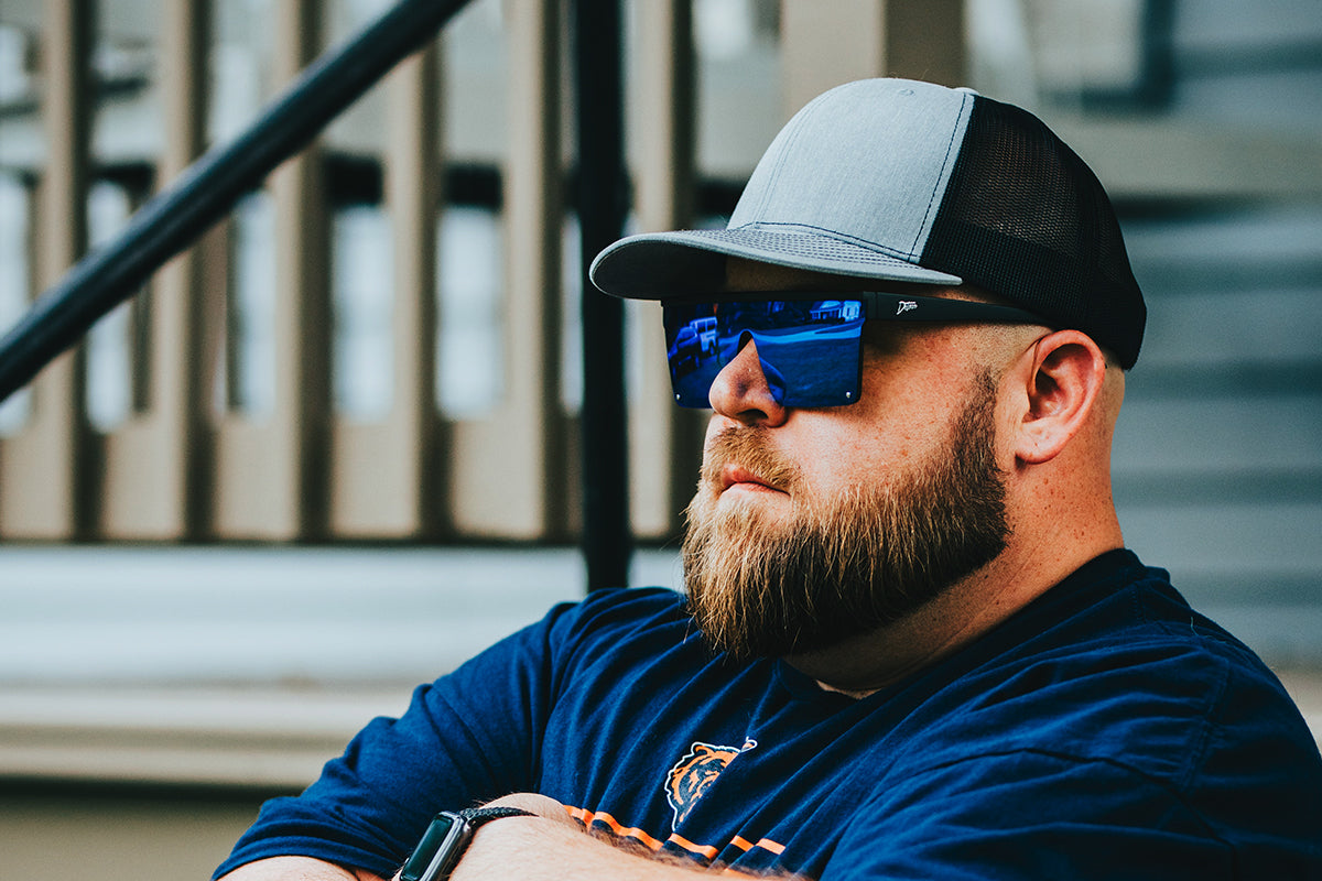 Snowboarder carving through powder in snowy terrain.